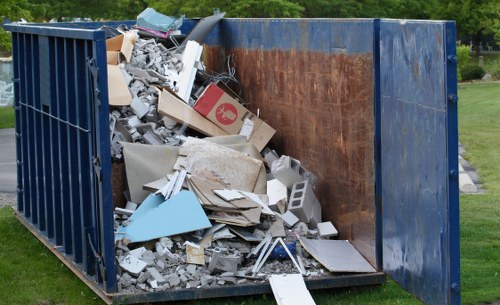 Clearance crew managing waste safely in a work area