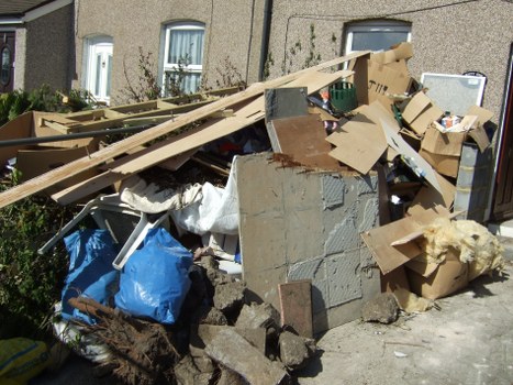 Local garage clearance team working in an Acton property with limited access